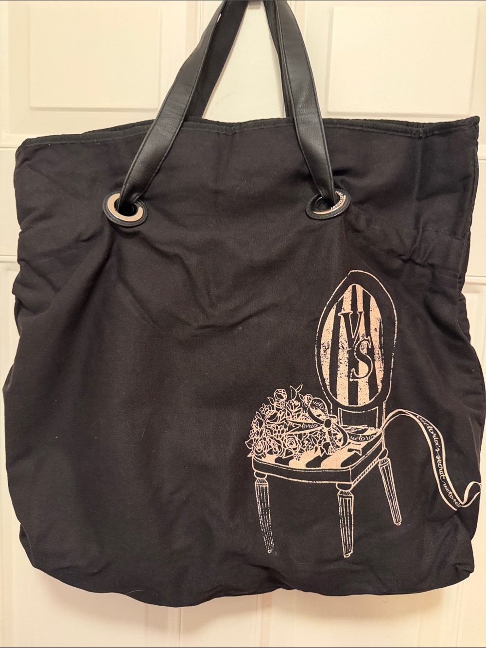 Victoria’s Secret Black Canvas Tote Bag with a striped chair and roses design